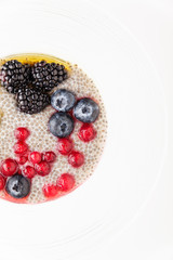 healthy vegan dessert with chia seeds pudding, cranberry, fresh blueberry and blackberries with  Maple syrup. Clean eating, dieting, detox, vegetarian food concept