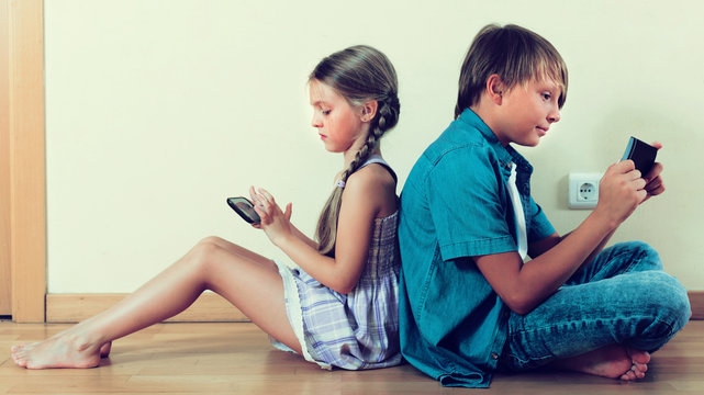 Two Kids Looking To Smartphone Screen
