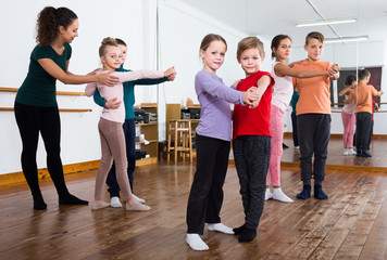 glad little boys and girls dancing pair dance