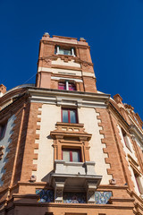 Windows in Brick Tower under Blue