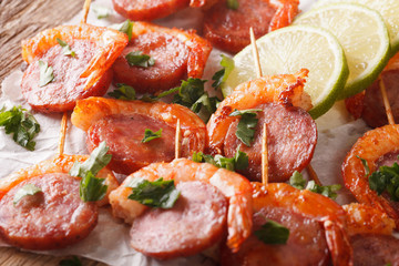 Fried shrimp and chorizo on skewers close-up. horizontal