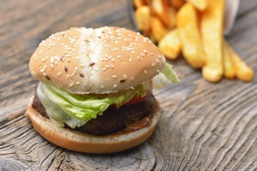 hamburger and french fries on wooden background