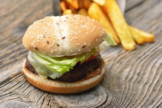 hamburger and french fries on wooden background