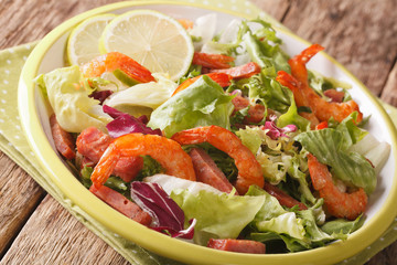 shrimp salad with chorizo and mix lettuce close-up on a plate. horizontal
