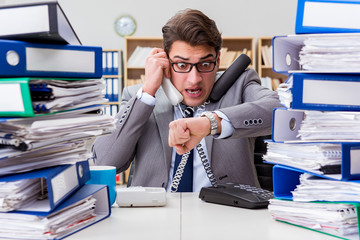 Busy businessman under stress due to excessive work