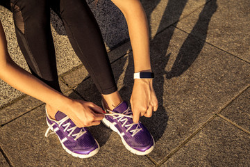 Athlete tying laces for running shoes.