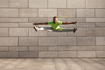 Sportsman jumping with spread legs