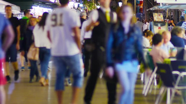 Barcelona, Multiple Tourists Strolling On Rambla Boulevard At Night.