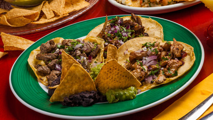 Mexican food: tacos with meat and chicken.