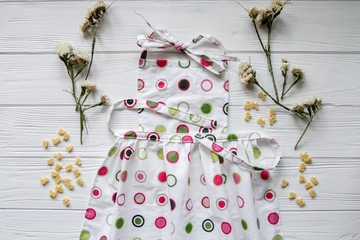 Kitchen apron on white background with flowers. Space for text