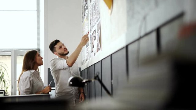 business, startup, education and people concept - creative architect team or students with blueprint working at office 20s 4k.