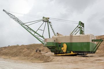 machine on sand quarry on a rainy day