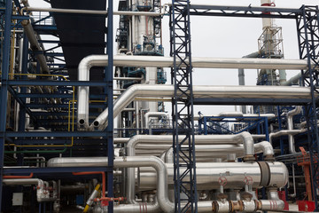 Close-up of pipelines and destillation tanks of an oil-refinery plant