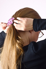 Naklejka premium Young girl combing Golden hair