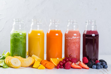 Fototapeta na wymiar Selection of colourful smoothies on rustic wood background