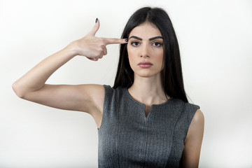 Obraz premium Business woman making gun with her hand.