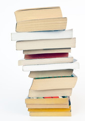 Irregularly stack of paperback books. Isolated.