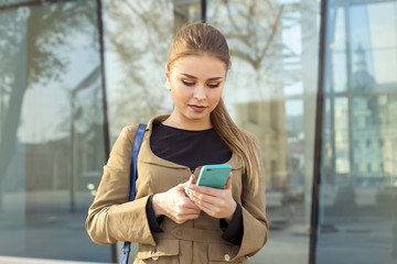 young woman writing sms on work.