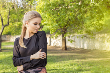 Pensive attractive blonde in a spring forest, came out for a walk