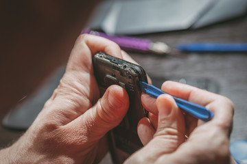 Fototapeta premium Man Repairing A Mobile phone