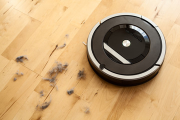 robotic vacuum cleaner on laminate wood floor smart cleaning technology dust