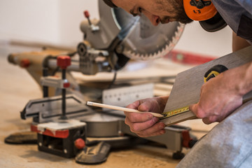 a man working with a miter saw