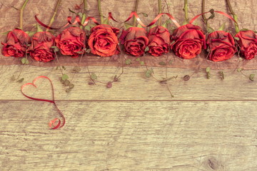 Wedding background.Valentines day background with red roses.  Top view, copy space. Vintage tone
