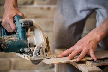 a man working with manual electric saw