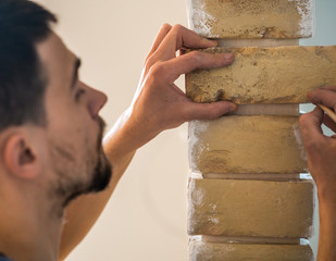 male works with brick wall with centimeter