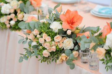 Newlyweds table decorated with bouquet and candles