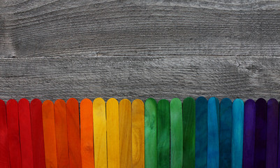 wooden sticks painted in different colors on a wooden table