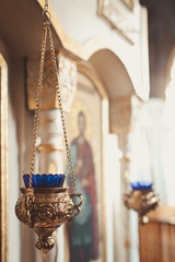 candles and lamp close-up. Interior Of Orthodox Church In Easter. baby christening. Ceremony a in Christian . bathing the into the baptismal font