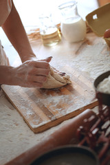 Fototapeta na wymiar Close up of female baker hands kneading dough and making bread