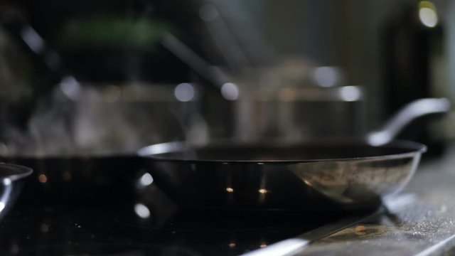 Close-up of pan with vapour on oven in kitchen