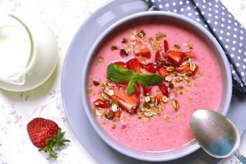 Strawberry oat smoothie in a gray bowl on a light background.