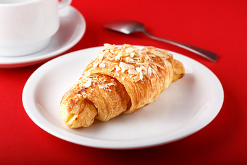breakfast croissant on a red background