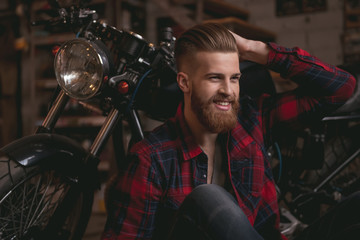 Guy in motorbike repair shop
