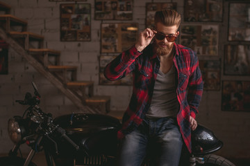 Guy in motorbike repair shop