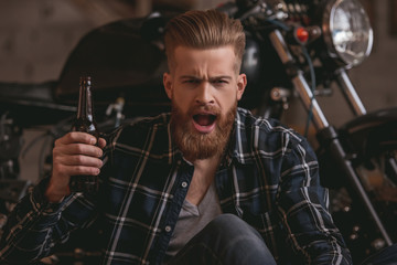 Guy in motorbike repair shop