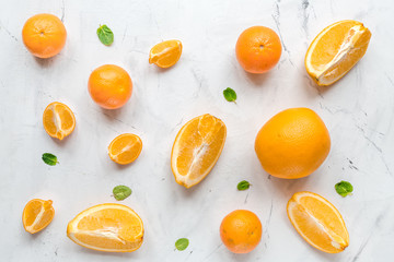 Making orange juice with mint on table background top view pattern