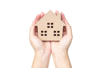 Hand holding a wooden house / Buying a house concept