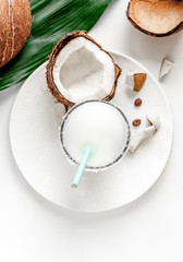 cocktail with coconut on white background top view