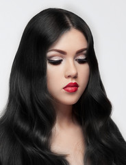 Fototapeta premium Beauty brunette model with long hair and red lips