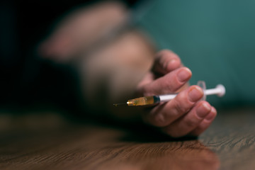 woman laying on the ground with needle in hand