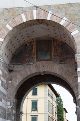 Front fragment of arch in Lucca, Italy.