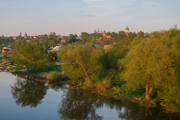 Spring evening landscape with the river and a small town on the shore.River Osetr and the city of Zaraysk in Moscow region
