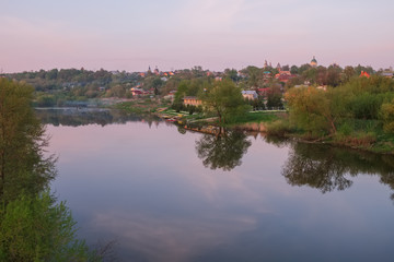 Fototapeta premium Spring evening landscape with the river and a small town on the shore.River Osetr and the city of Zaraysk in Moscow region