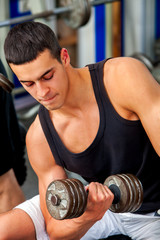 Fototapeta na wymiar Men in gym workout weights with fitness equipment. Man holding dumbbell workout at gym. Chrome dumbbells in strong male hands.