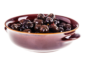 Black olives bowl on white