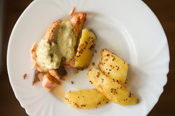 Grilled salmon with roasted sweet potato and wakame sauce on the white plate